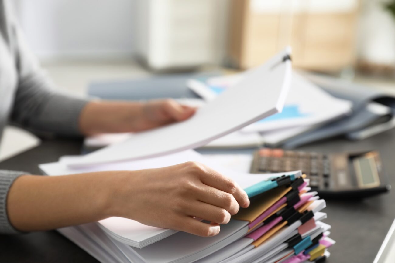 office employee working with documents at table, closeup